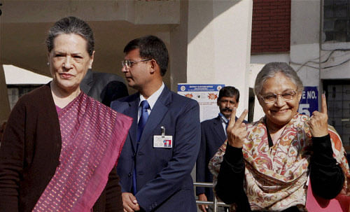 UPA Chairperson Sonia Gandhi with Delhi Chief Minister Sheila Dikshit after casting votes for Delhi Assembly elections at Nirman Bhawan polling station in New Delhi on Wednesday. PTI Photo by Vijay Verma