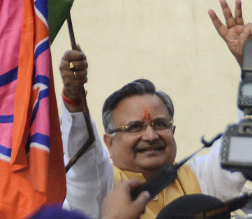 Chhattisgarh CM Raman Singh flashes hat-trick sign after BJP's win in the Assembly elections in Raipur on Sunday. PTI Photo