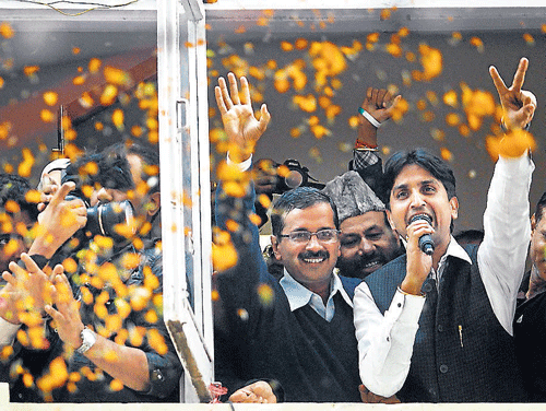 Arvind Kejriwal waves to his supporters at party office in New Delhi on Sunday. REUTERS