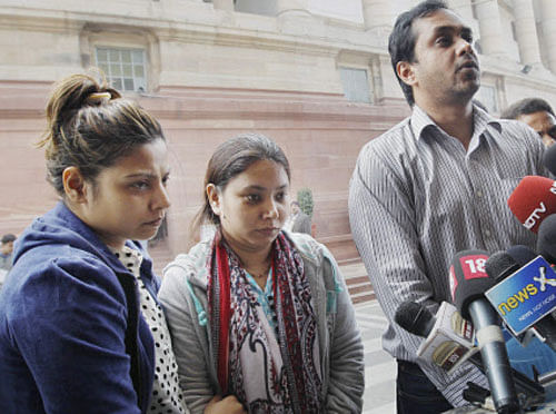 Aditi James (C), wife of merchant navy captain Sunil James, after meeting Prime Minister Manmohan Singh at Parliament house in New Delhi on Tuesday. Also seen in the picture are Sunil's sister Anvi and brother-in-law Rakesh Mudappa. They met the PM to secure release of his husband from a month-long detention in western-African country Togo, where he is facing charges of abetting pirates. PTI Photo