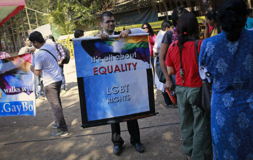 A gay rights activist folds a banner at a protest organised against the Supreme Court's order on gay sex in Mumbai Reuters Image