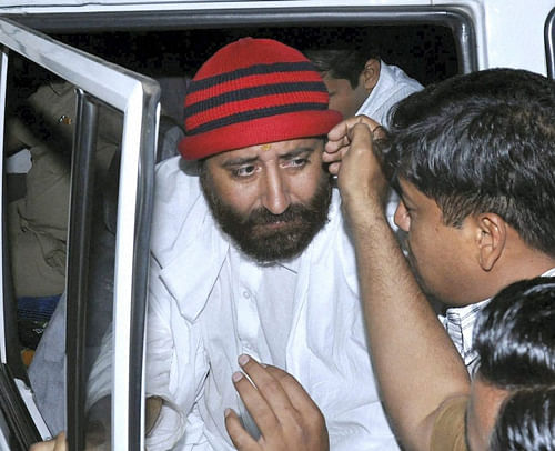 A sub-inspector and five aides of self-styled godman Asaram's son Narayan Sai (in pic) were detained today for allegedly attempting to bribe the cops and other officials in a bid to weaken the sexual assault case against him and Rs five crore seized from their possesion. PTI File Photo.