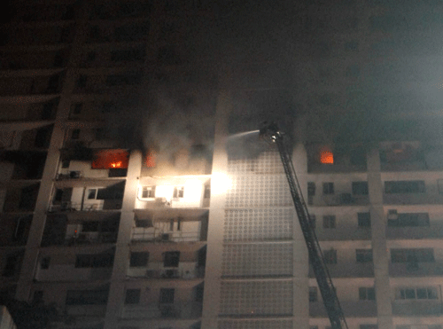 Fire fighters dousing a fire that broke out on 12th floor of a 26-story residential building at Warden Road in South Mumbai on Friday. PTI Photo
