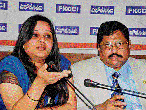 Superintendent of Police, CID (Cyber Crime), Roopa D, speaks at a programme on Information Security in the City on  Friday. FKCCI president R Shivakumar is with her. dh photo