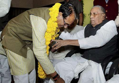 Madhya Pradesh Chief Minister Shivraj Singh Chouhan seeks blessing from his political guru and former CM Sunderlal Patwa after he was elected as the Leader of BJP Legislative Party, in Bhopal on Friday. PTI Photo