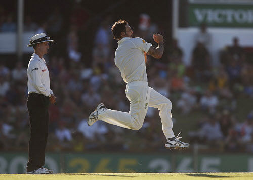 Australia's Mitchell Johnson runs in to bowl a delivery against England on the second day of their Ashes cricket test match in Perth, Australia, Saturday, Dec. 14, 2013. AP Photo
