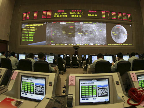 In this photo taken Tuesday, Dec. 10, 2013, researchers work in the control room of the Chang'e 3 lunar probe at the Beijing Aerospace Control Center in Beijing, China. AP Photo