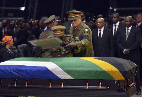 Officers leave a frame on coffin of former South African President Nelson Mandela during the funeral ceremony of in Qunu December 15, 2013. REUTERS