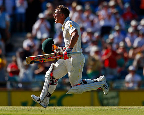 Australia's David Warner celebrates his century during the third day of the third Ashes test cricket match against England at the WACA ground in Perth December 15, 2013. REUTERS