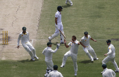 The Australian team celebrates after taking the wicket of England's Alastair Cook (top C) during the fourth day of the third Ashes test cricket match at the WACA ground in Perth December 16, 2013. REUTERS