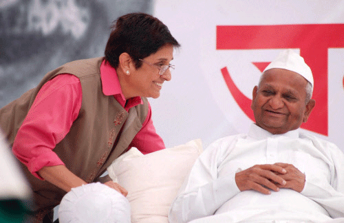 Former IPS officer and social activist Kiran Bedi having a word with Anna Hazare during the Fifth day of his indefinite hunger strike for Jan Lokpal Bill, at his village in Ralegan Siddhi in Ahmednagar district on Saturday. PTI Photo