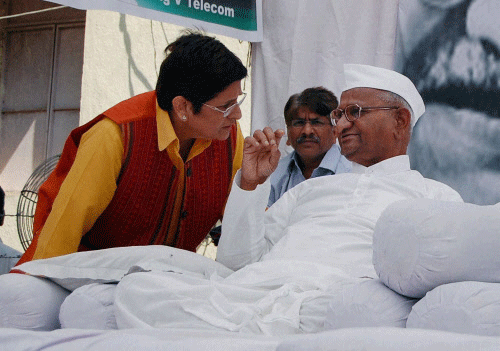 Former IPS officer and social activist having a word with Anna Hazare during the second day of his indefinite hunger strike for Jan Lokpal Bill, at his village in Ralegan Siddhi in Ahmednagar district on Wednesday. PTI Photo