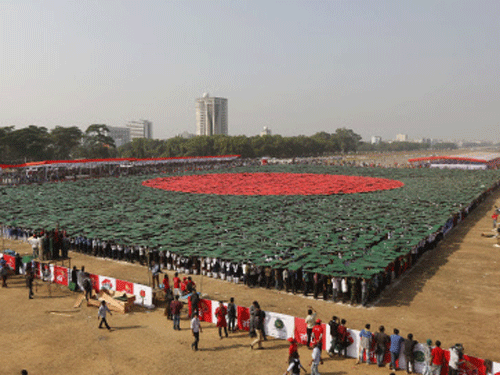 Volunteers form a large flag of Bangladesh as the nation celebrates National Victory Day at the National Parade ground in Dhaka December 16, 2013. According to the organizers, 27,117 volunteers formed a large human national flag for six minutes and sixteen seconds as they attempted to set a new Guinness world record. Bangladesh won independence from Pakistan on December 16, 1971, following a nine-month guerrilla war which cost millions of lives. REUTERS