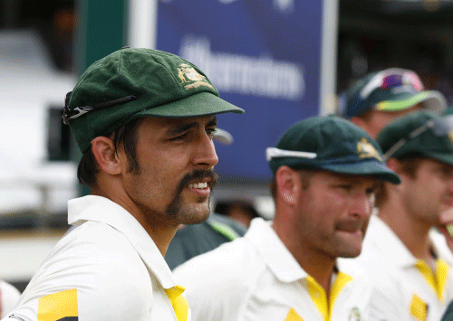 Australia's Mitchell Johnson, left, and team mate Ryan Harris, right, react after winning their Ashes cricket test match over England,Tuesday, Dec. 17, 2013, in Perth, Australia. Australia won the match by 150 runs and take an unbeatable 3-0 lead in the five game series. AP photo