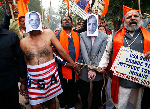 Rashtrawadi Shivsena supporters walk with a handcuffed person representing US President Barack Obama near the US embassy to protest against the alleged mistreatment of New York-based diplomat Devyani Khobragade, in New Delhi on Wednesday.  AP