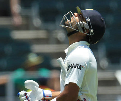 India's batsman Virat Kohli reacts as he walks back to the pavilion after his dismissal for 96 runs, during their 2nd innings on the fourth day of their cricket test match against South Africa at Wanderers stadium in Johannesburg, South Africa, Saturday, Dec. 21, 2013. AP Photo
