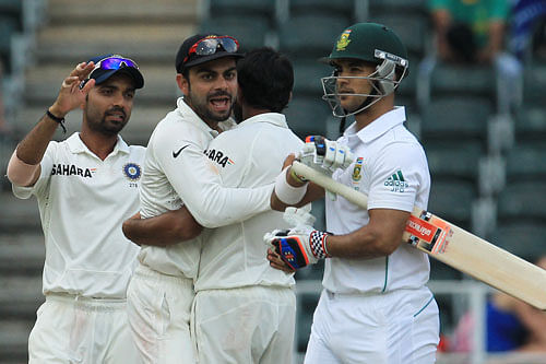 ndia's Virat Kohli, center, embraces bowler Mohammad Shami, second from right, for bowling out South Africa's batsman Jean-Paul Duminy, right, for 5 runs during the fourth and final day of their cricket test match against India at Wanderers stadium in Johannesburg, South Africa, Sunday, Dec. 22, 2013. AP Photo