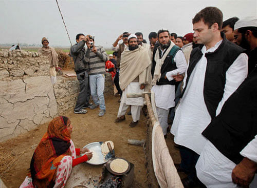 AICC Vice President Rahul Gandhi interacts with the residents during his visit to Muzaffarnagar Victim Family Camp in Samli on Sunday. PTI Photo
