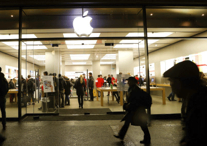 People walk past an Apple Store at the Bahnhofstrasse shopping street in Zurich December 19, 2013. REUTERS