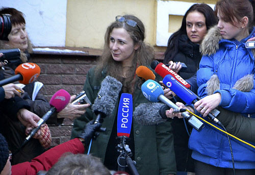 Maria Alekhina, second from left, a member of the Russian punk band Pussy Riot peaks to the media at the Committee against Torture after being released from prison, in Nizhny Novgorod, on Monday, Dec. 23, 2013. Alekhina, and two other band members, Nadezhda Tolokonnikova and Yekaterina Samutsevich, were found guilty of hooliganism motivated by religious hatred and sentenced to two years in prison for the performance at Moscow's main cathedral in March 2012. Samutsevich was released several months later on suspended sentence. AP