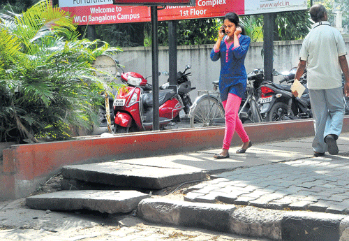 watch out Uneven foothpaths are a common sight in the City. DH Photo by Janardhan BK