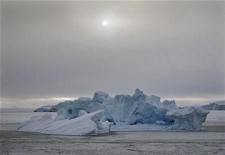 File photo of an iceberg floats in the sea ice near the town of Uummannaq in western Greenland. Reuters/SVEBOR KRANJC