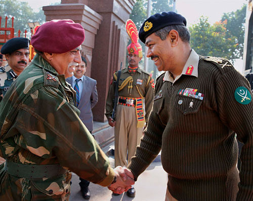 Pakistan Army DGMO Maj Gen Aamer Riaz and Indian Army DGMO Lt Gen Vinodh Bhatia before the delegation level meeting at the Wagah-Attari border on Tuesday. PTI Photo