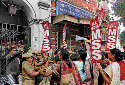 Police personnel try to stop protesters during a demonstration against the rape in Kolkata on Tuesday. PTI