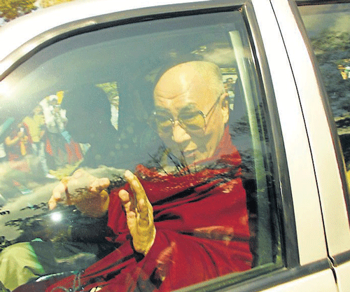 Tibetan spiritual leader Dalai Lama greets people on his arrival at Bylukuppe, Periyapatna taluk, Mysore district, on Tuesday. dh photo