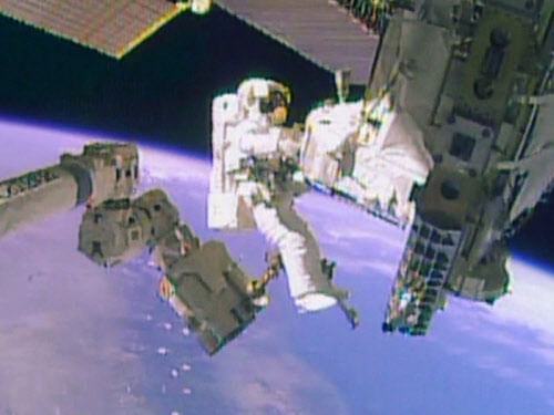 Astronaut Mike Hopkins works outside the International Space Station during a spacewalk, December 24, 2013, in this still image taken from video courtesy of NASA. Two NASA astronauts floated outside the International Space Station on Tuesday for a second and final spacewalk to fix the outpost's critical cooling system. Reuters.
