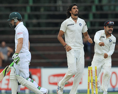 India's bowler Ishant Sharma, center, celebrates with teammate Virat Kohli, right, for bowling South Africa's batsman Abraham Benjamin de Villiers, left, for 103 runs during the fourth and final day of their cricket test match at Wanderers stadium in Johannesburg, South Africa, Sunday, Dec. 22, 2013. AP Photo