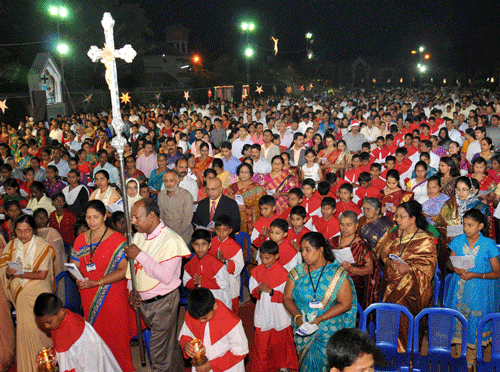 Devotees praying at a Christmas Festival celebrations in midnight at Kulashekar Church in Mangalore on Wednesday DH Photo
