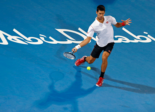 Novak Djokovic of Serbia hits a return to Jo-Wilfried Tsonga of France during their semi-final tennis match at the Mubadala World Tennis Championship in Abu Dhabi December 27, 2013. REUTERS