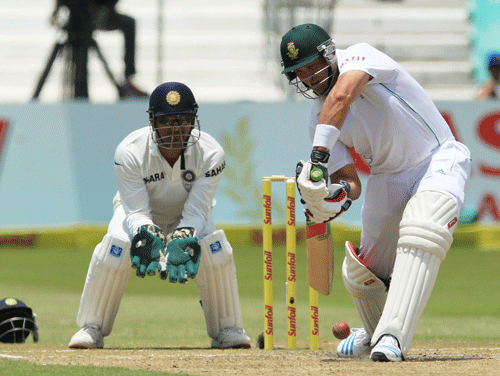 South Africa's batsman Jacques Kallis, right, plays a shot as India's captain Mahendra Singh Dhoni, left, watches on the third day of their cricket test match at Kingsmead stadium, Durban, South Africa, Saturday, Dec. 28, 2013. AP Photo