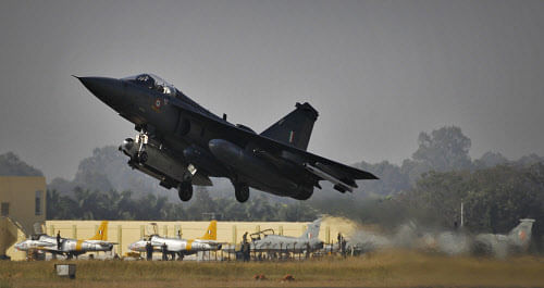 India's indigenously designed and developed combat aircraft Tejas takes off during its air display at Hindustan Aeronautics Limited airport in Bangalore, India, Friday, Dec. 20, 2013. Tejas, a single engine, single seat, supersonic, multirole light combat aircraft got Initial Operational Clearance (IOC II) Friday a milestone towards its induction into Indian Air Force for operations. AP photo