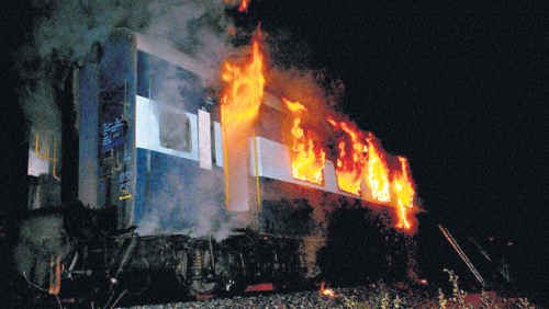 BURNING&#8200;TRAIN: The AC coach of the Bangalore-Nanded Express in flames in Anantapur district on Saturday. PTI