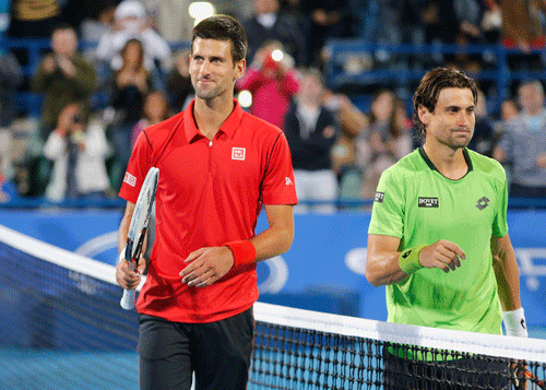 Novak Djokovic of Serbia (L) and David Ferrer of Spain walk together at the end of their final tennis match at Mubadala World Tennis Championship in Abu Dhabi December 28, 2013. REUTERS