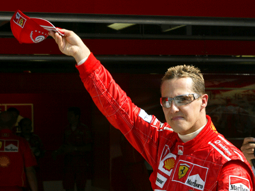 File photo of Ferrari Formula One world champion driver Schumacher waving to supporters at the end of the second free practice session for the Italian Grand Prix. Reuters
