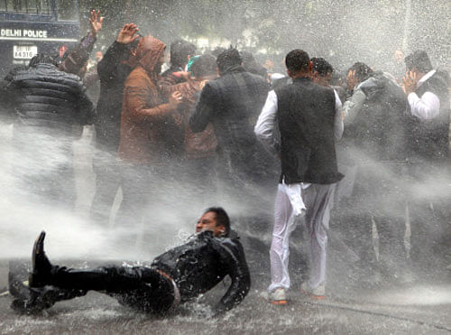 Police use water cannons on BJP's youth wing activists demonstrating outside Congress Vice-President Rahul Gandhi's residence demanding explanation from him on corruption charges against Himachal Pradesh Chief Minister Virbhadra Singh, in New Delhi on Tuesday. PTI Photo