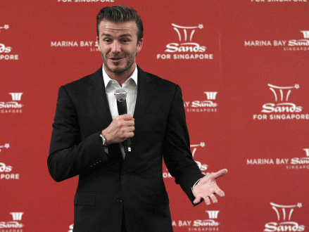 FILE - In this July 7, 2013, file photo, former soccer star David Beckham greets media and youth in Singapore at the Marina Bay Sands. AP photo