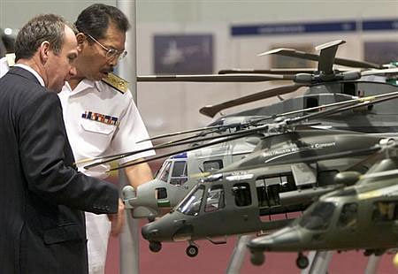 Visitors look at AgustaWestland model helicopters during Heli-Asia exhibition in Kuala Lumpur October 22, 2002. File photo - Reuters