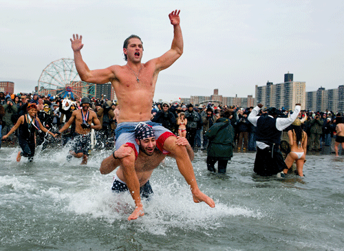 Hundreds of brave Torontonians took an icy dip into Lake Ontario to kick off the new year as the country remains locked in a deep freezen Wednesday. AP