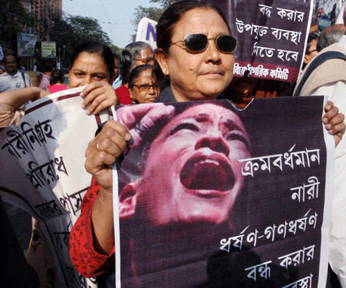 People take part in a protest rally in Kolkata against the rape of a 16 years old girl . PTI Photo
