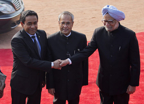 Maldives President Abdulla Yameen (L) shakes hands with Indian Prime Minister Manmohan Singh, as Indian President Pranab Mukherjee (C) watches during Yameen's ceremonial reception at the forecourt of India's presidential palace Rashtrapati Bhavan in New Delhi January 2, 2014. Yameen is on a four-day state visit to India. REUTERS