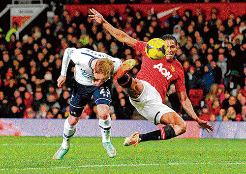 on target: Tottenham Hotspur's Christian Eriksen (left) beats United's Antonio Valencia to head in their second goal. AFP