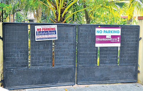There are at least two boards hanging on the gates of private residences at any given time.