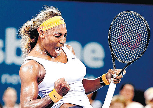 Brute force: Serena Williams exults after recording her 14th consecutive win over Maria Sharapova at the Brisbane International on Friday. Reuters