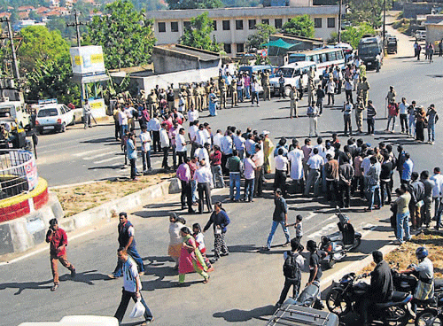 Members of different organisations stage a protest by blocking the road at General Thimmaiah Circle in Madikeri on Saturday. DH Photo