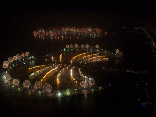 In this photo provided by Dubai World Record 2014, fireworks explode over Palm Jumeirah Island, front, and World Islands, rear, to celebrate the New Year on Wednesday, Jan. 1, 2014 as the city attempts to breaks the Guinness World Record for the 'Largest Firework Display.' AP Photo