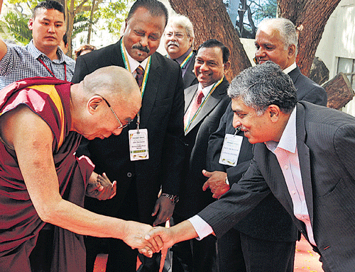 Nobel laureate, the 14th Dalai Lama, greets UIDAI chairperson Nandan Nilekani at a principals' conference in Bangalore on Sunday. DH Photo